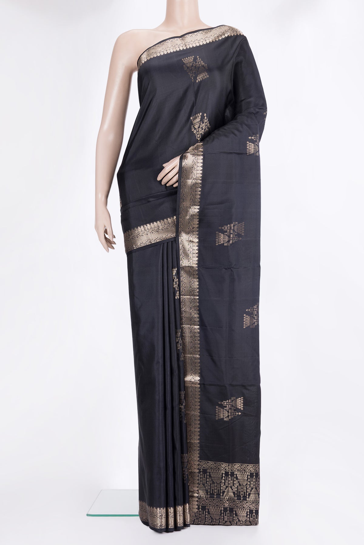 Pure Silk Black Soft Saree with Zari Butta on the body and Zari Border.  displayed on a mannequin