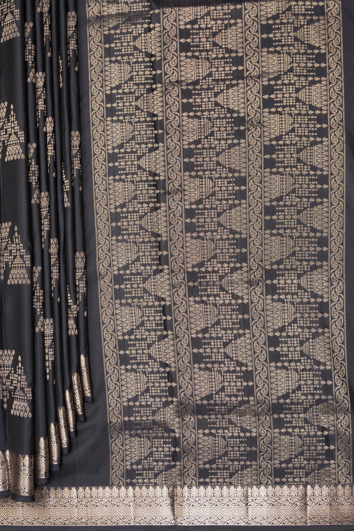 Pleats and pallu of Pure Silk Black Soft Saree with Zari Butta on the body and Zari Border. 