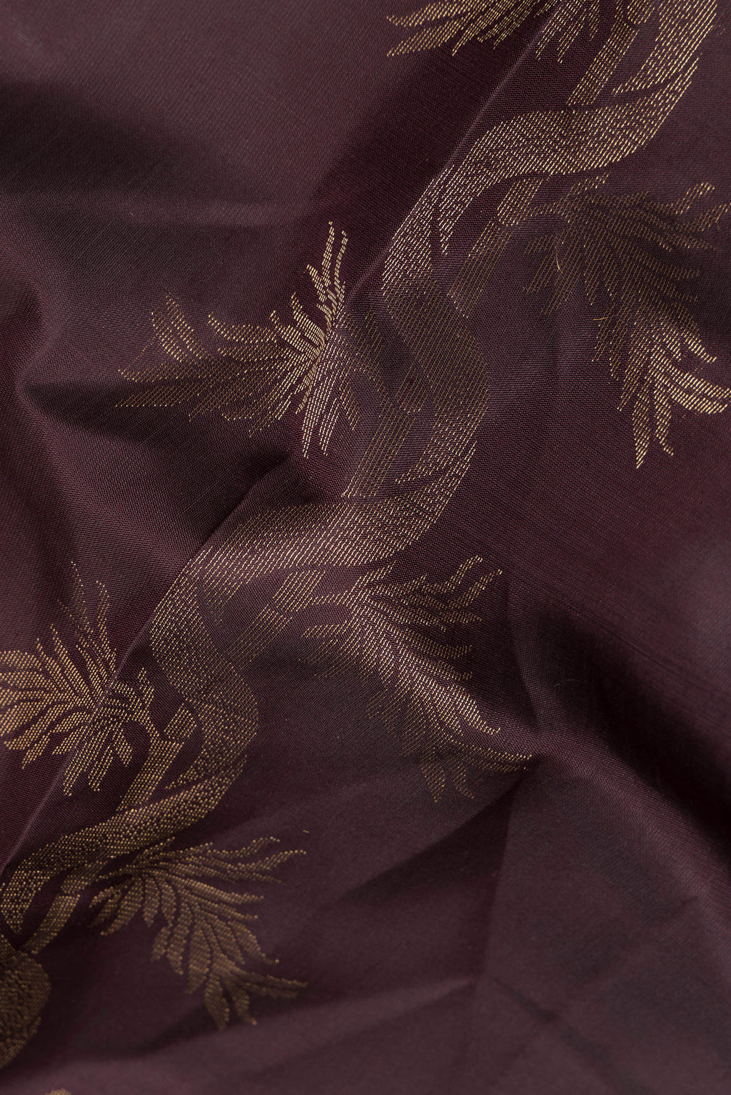 Close up of Pure Silk Coffee Brown Soft Saree with Zari Butta on the body and Without Border.  displaying folds