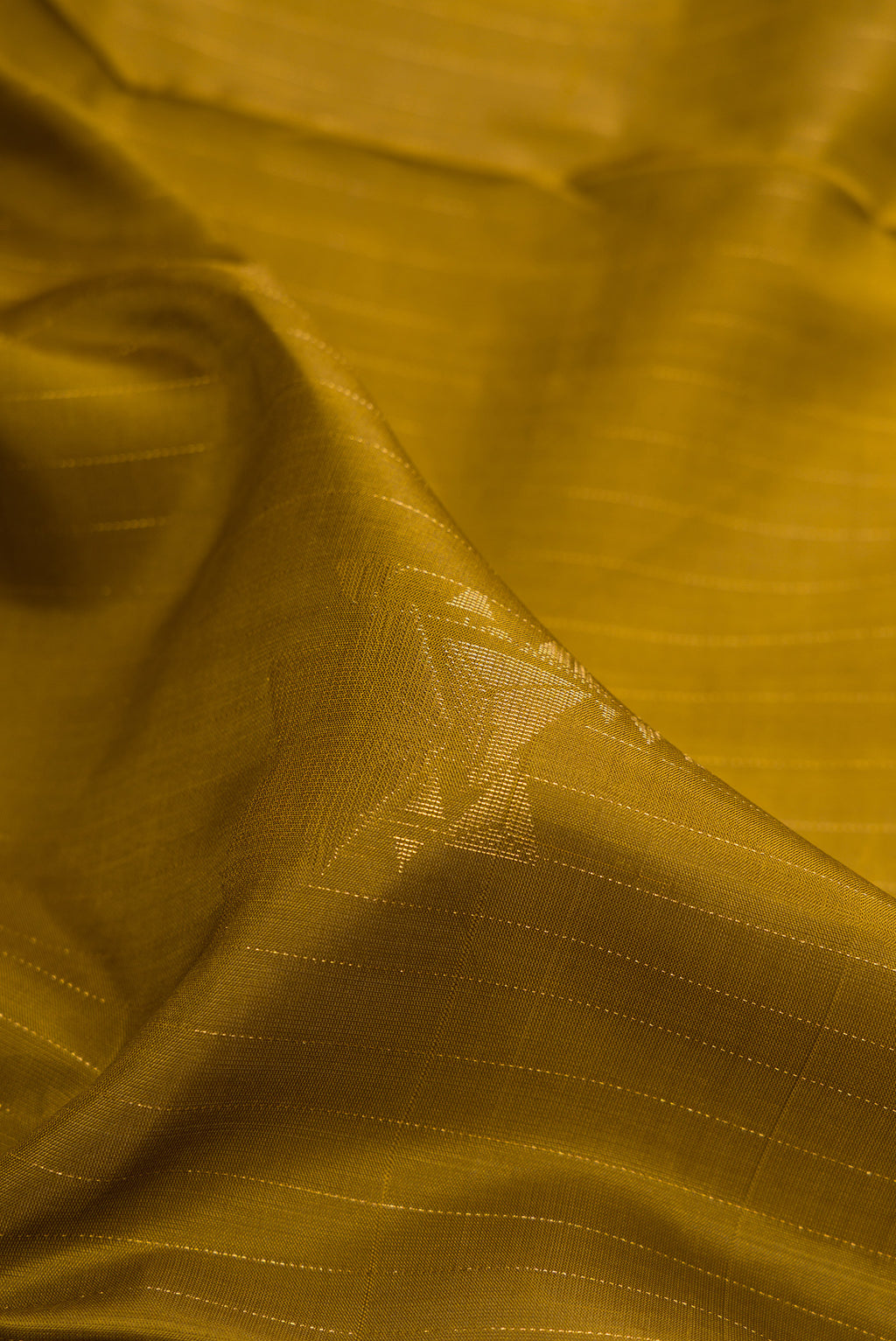 Close up of Pure Silk Mehandi Green Soft Saree with Stripes on the body and Without Border.  displaying folds