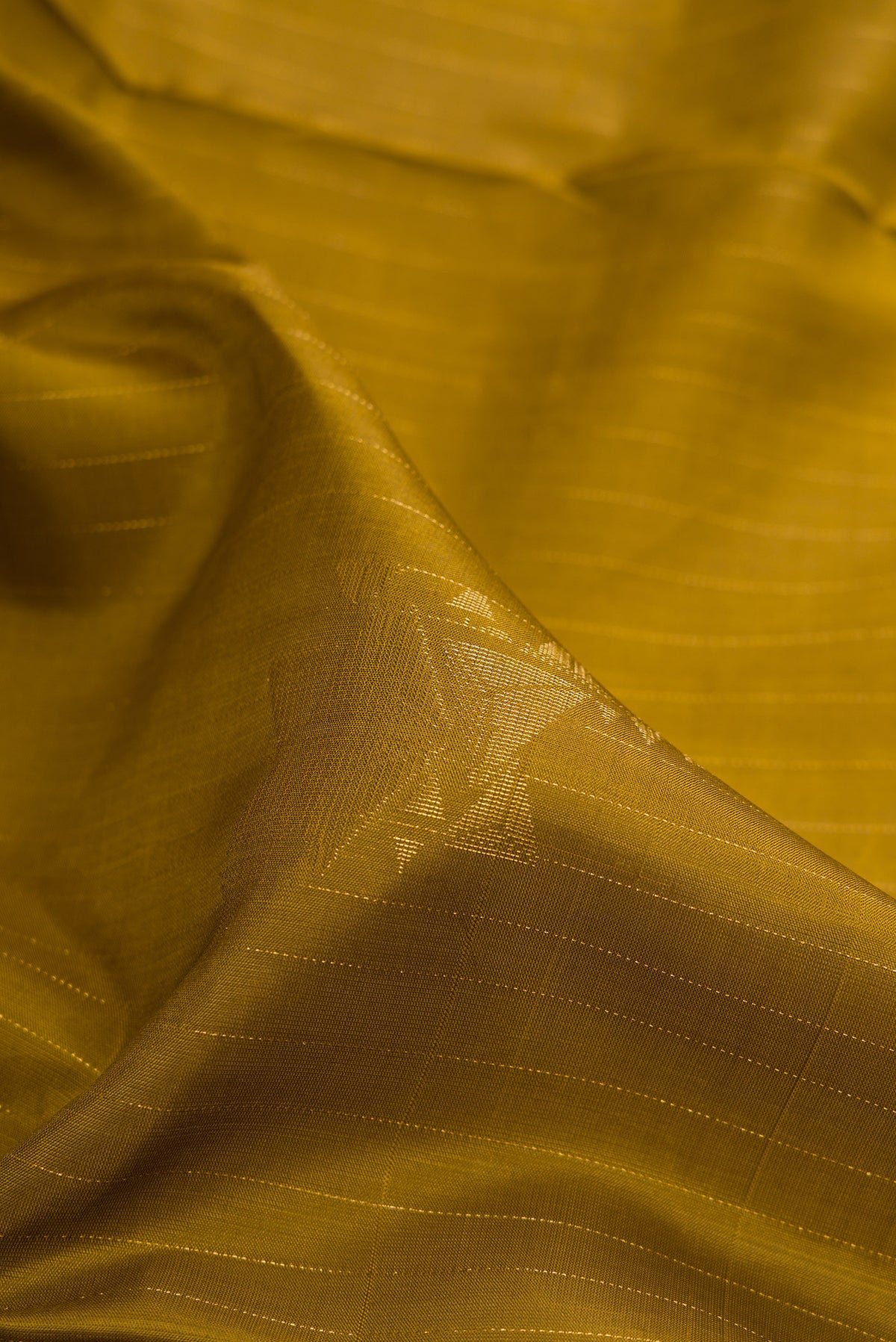 Close up of Pure Silk Mehandi Green Soft Saree with Stripes on the body and Without Border.  displaying folds