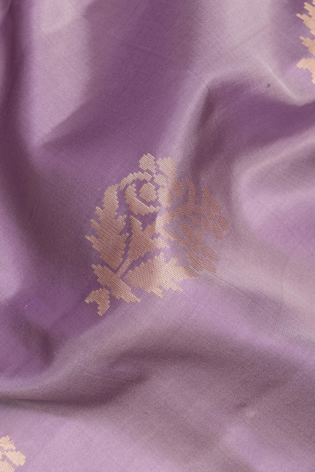 Close up of Pure Silk Lilac Soft Saree with Zari Butta on the body and Zari Border.  displaying folds