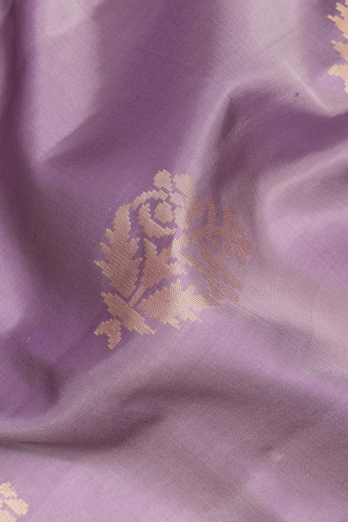 Close up of Pure Silk Lilac Soft Saree with Zari Butta on the body and Zari Border.  displaying folds