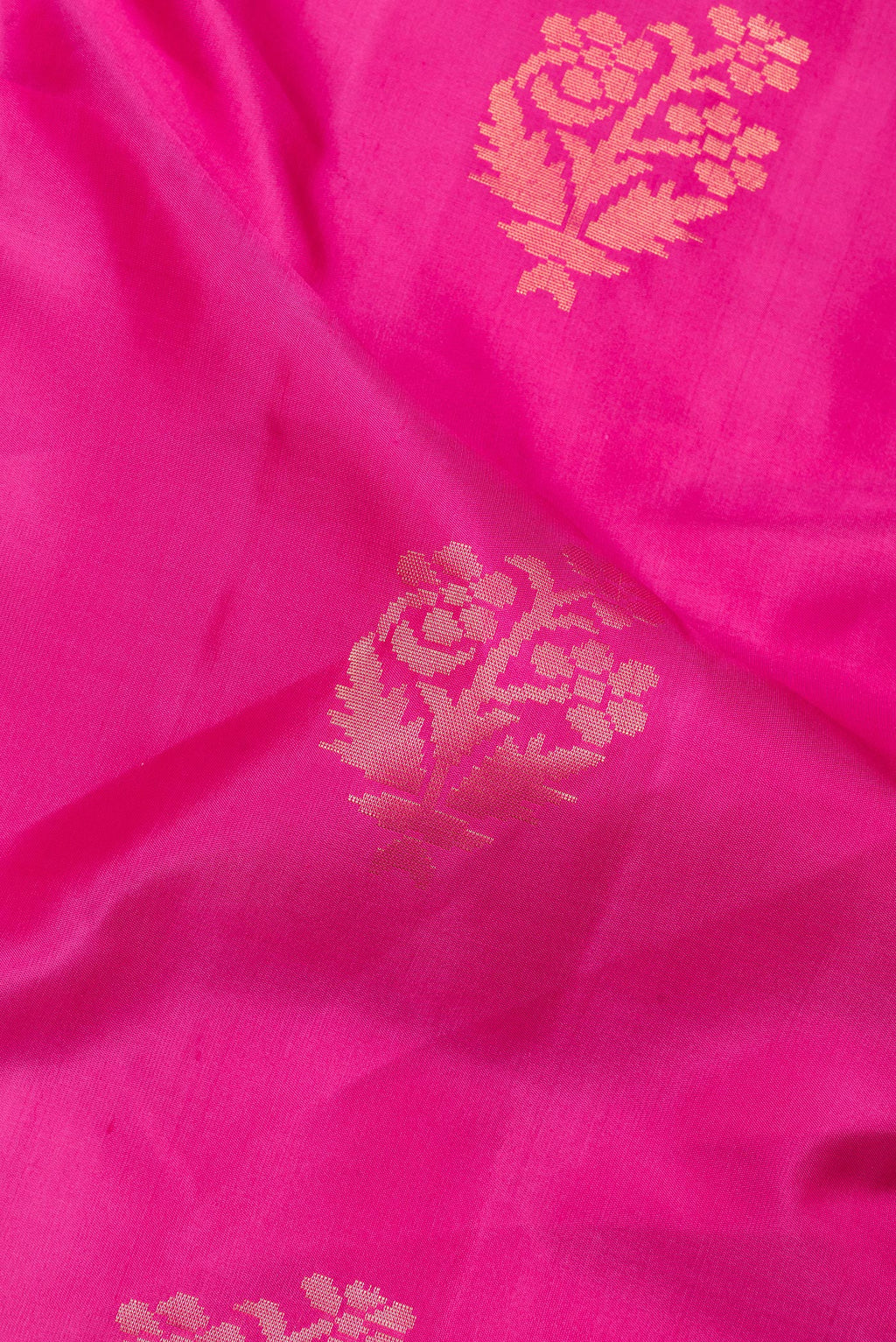 Close up of Pure Silk Dark Pink Soft Saree with Zari Butta on the body and Zari Border.  displaying folds