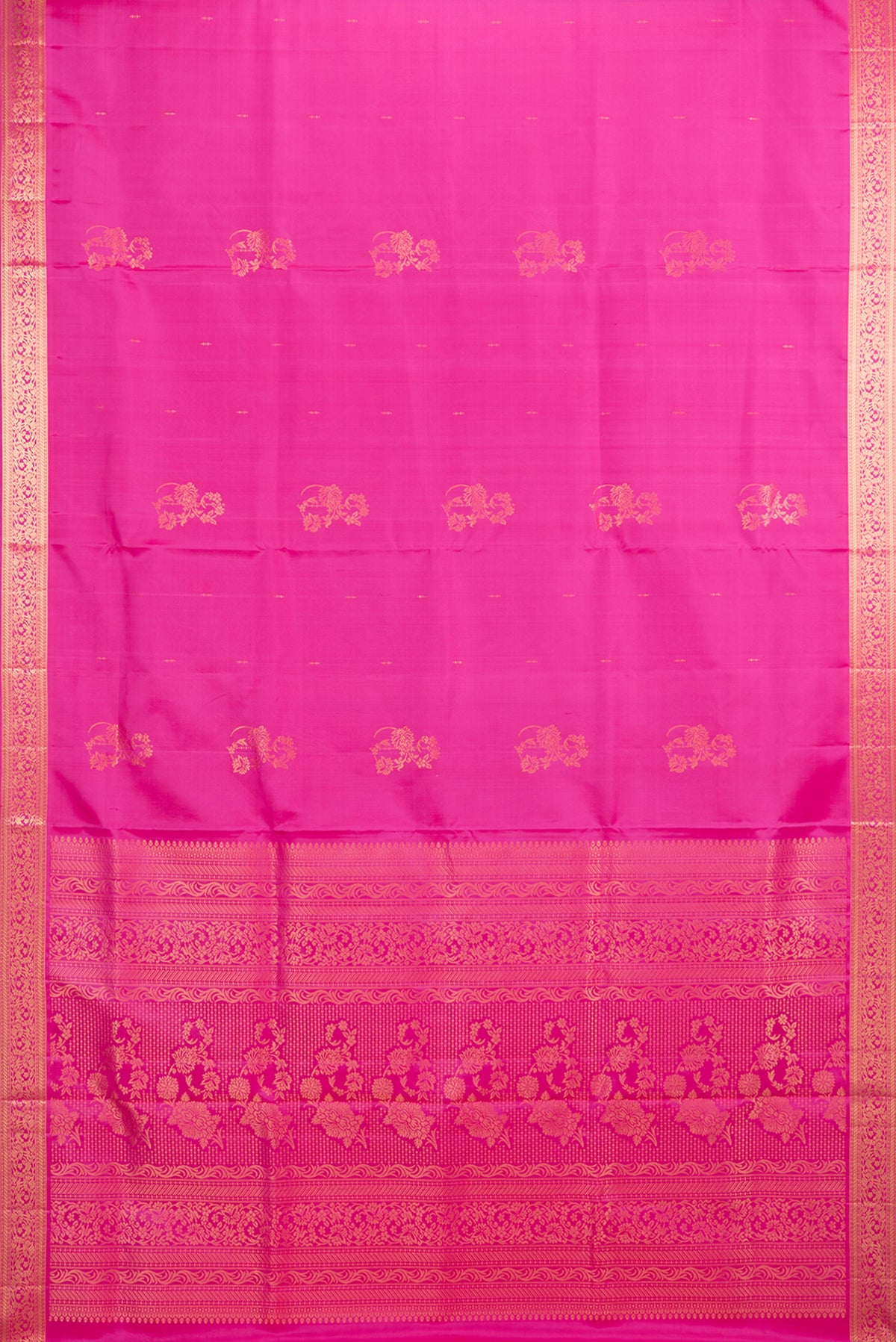 Flat view of Pure Silk Rani Pink Soft Saree with Zari Butta on the body and Zari Border. 
