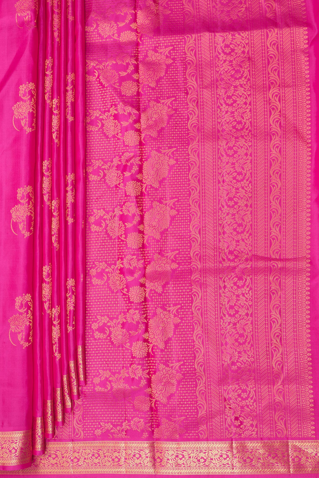 Pleats and pallu of Pure Silk Rani Pink Soft Saree with Zari Butta on the body and Zari Border. 