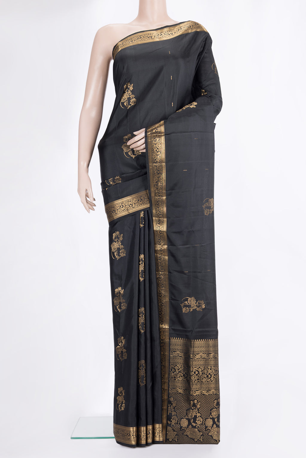 Pure Silk Black Soft Saree with Zari Butta on the body and Zari Border.  displayed on a mannequin