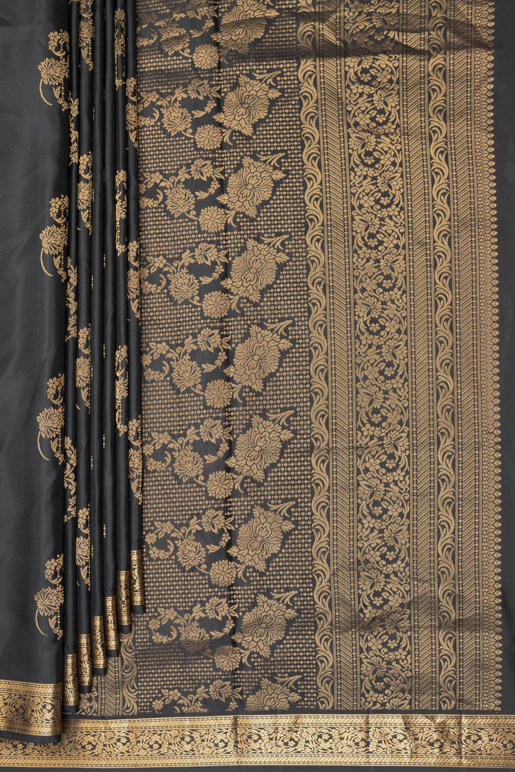 Pleats and pallu of Pure Silk Black Soft Saree with Zari Butta on the body and Zari Border. 