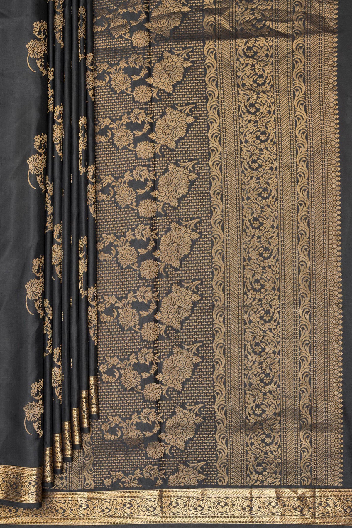 Pleats and pallu of Pure Silk Black Soft Saree with Zari Butta on the body and Zari Border. 
