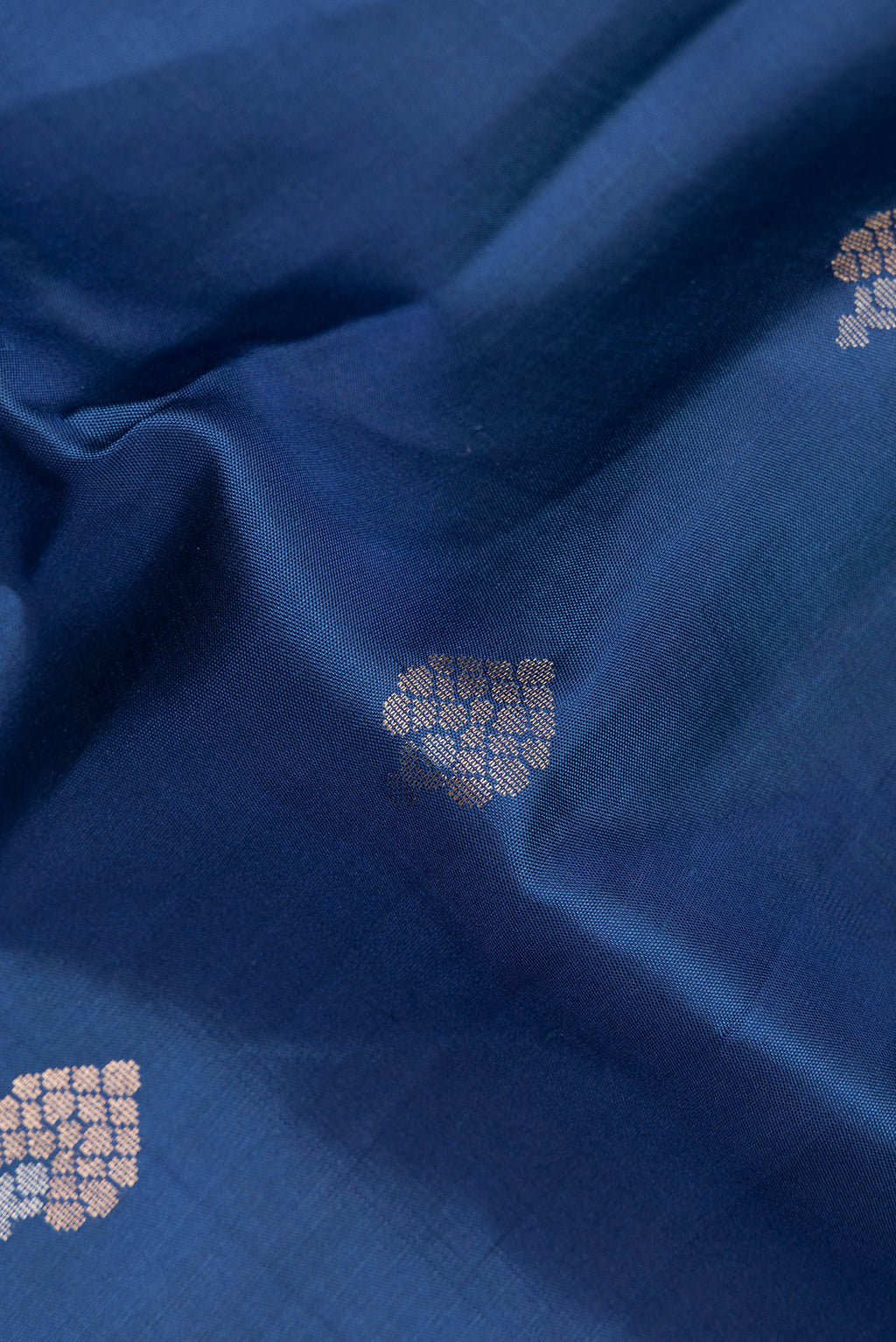 Close up of Pure Silk Blue Soft Saree with Zari Butta on the body and Zari Border.  displaying folds