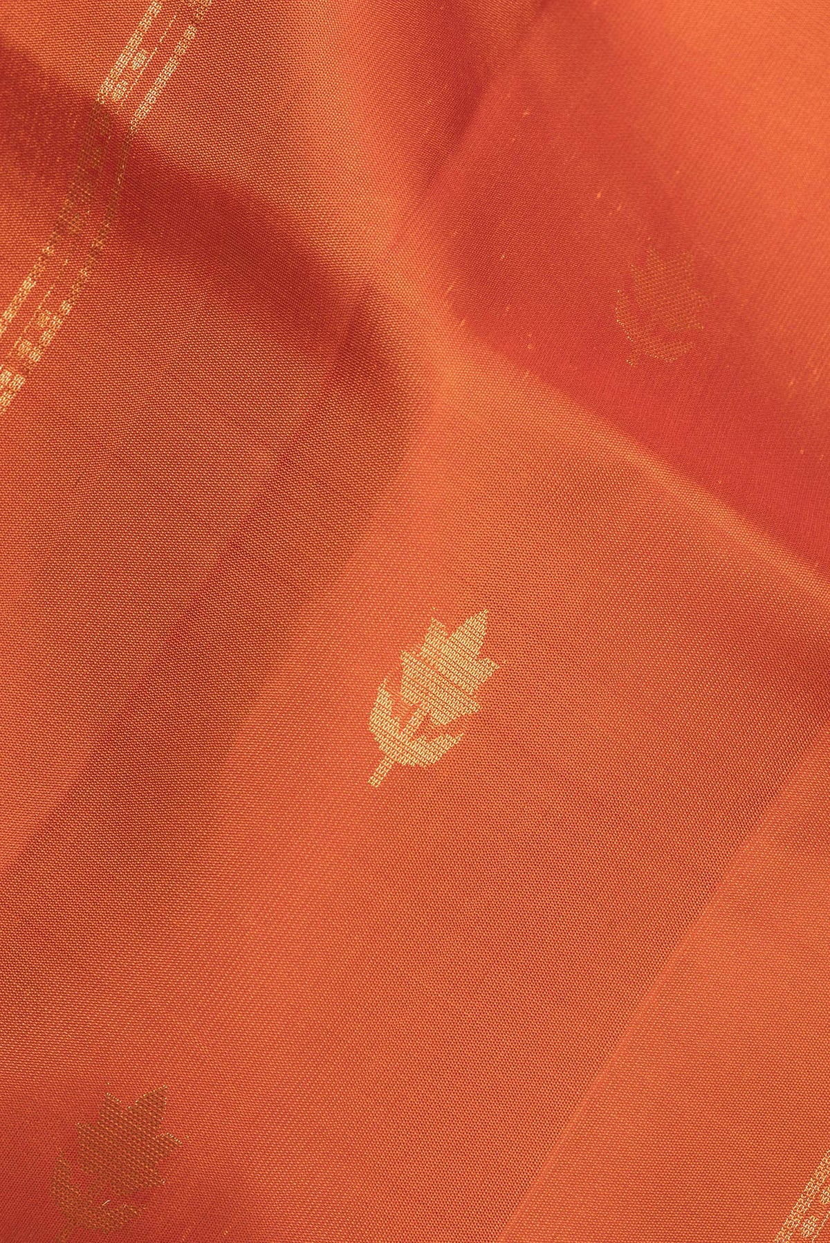 Close up of Pure Silk Rust Dual Tone Soft Saree with Stripes on the body and Without Border.  displaying folds