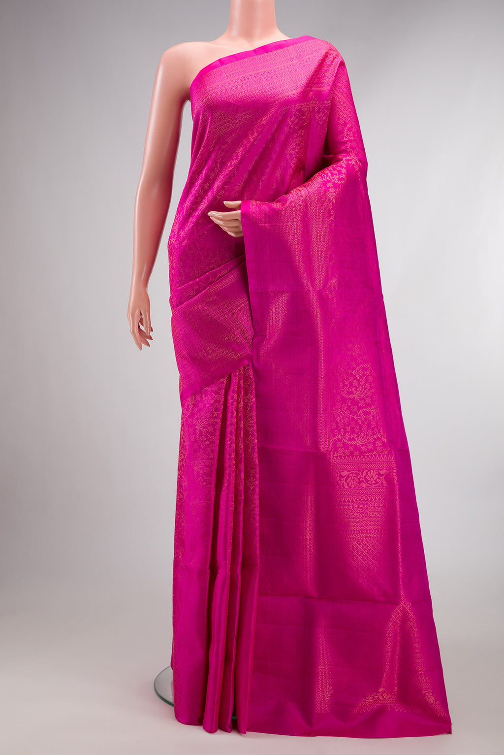 Pure Silk Rani Pink Soft Saree with Zari Brocade on the body and Fancy Border.  displayed on a mannequin