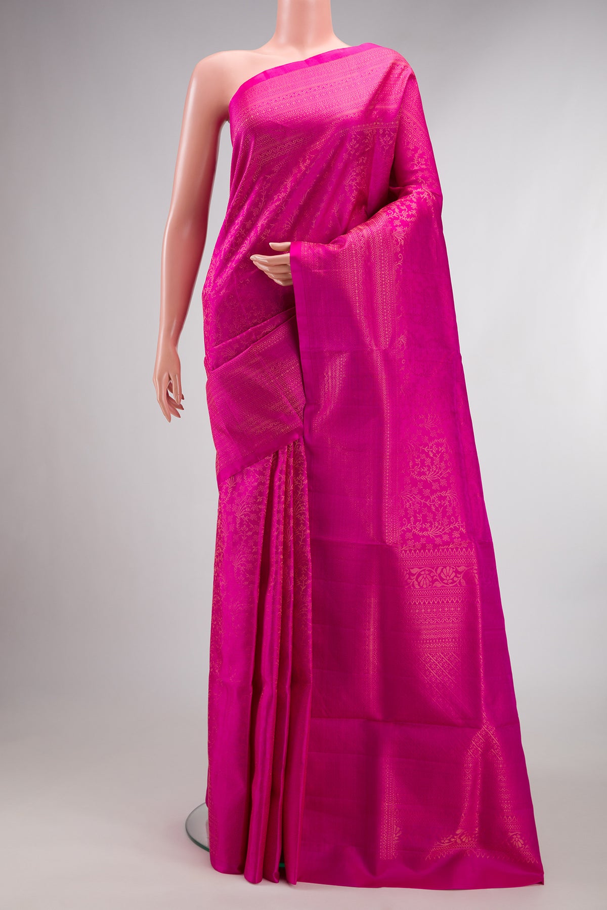 Pure Silk Rani Pink Soft Saree with Zari Brocade on the body and Fancy Border.  displayed on a mannequin