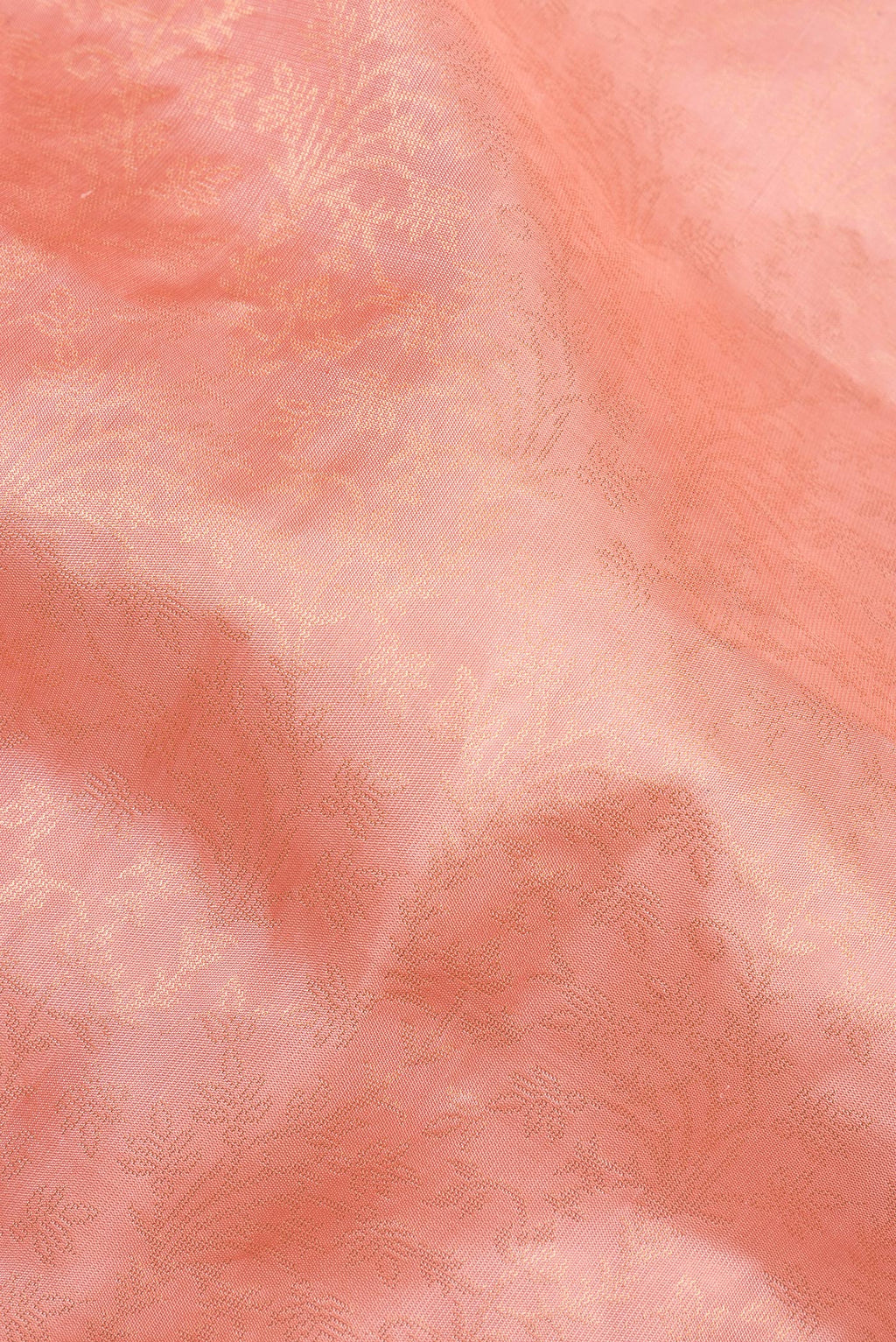 Close up of Pure Silk Peach Soft Saree with Zari Brocade on the body and Fancy Border.  displaying folds