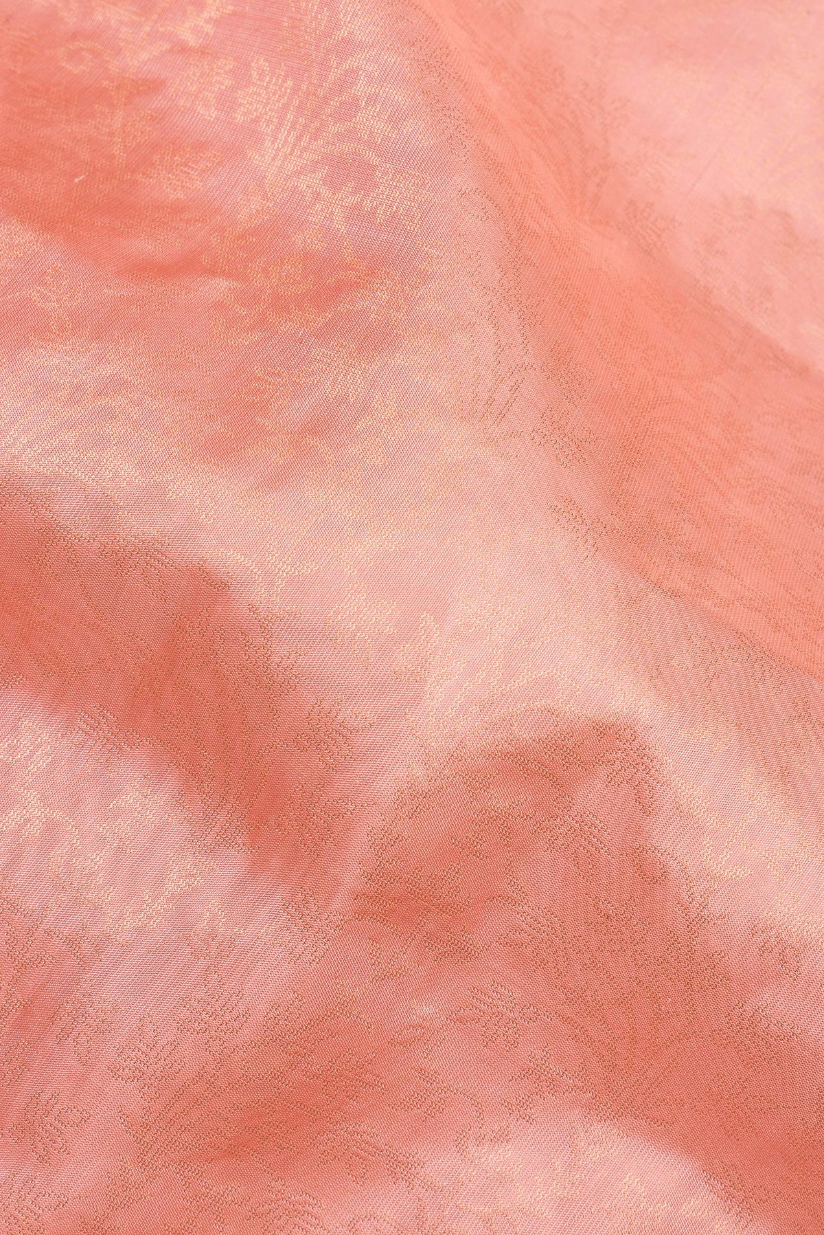 Close up of Pure Silk Peach Soft Saree with Zari Brocade on the body and Fancy Border.  displaying folds