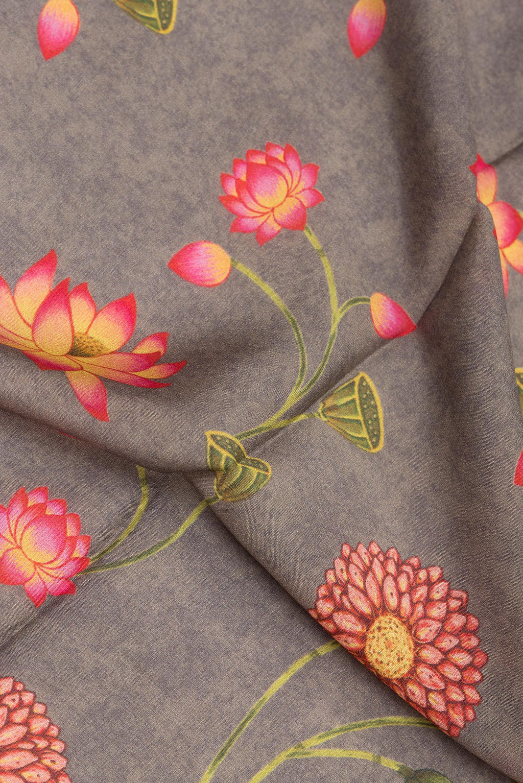 Close up of Grey Crepe Saree with Floral Print on the body and Zari Border.  displaying folds