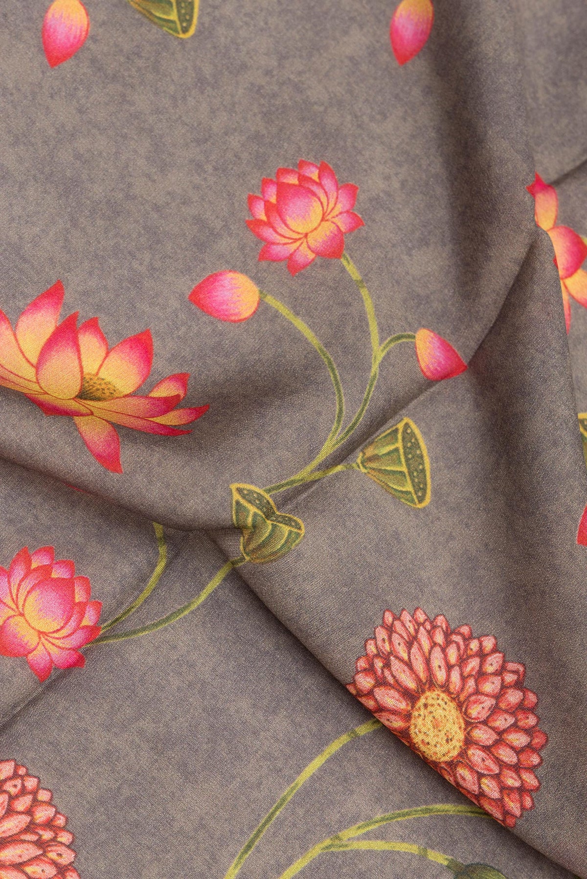 Close up of Grey Crepe Saree with Floral Print on the body and Zari Border.  displaying folds