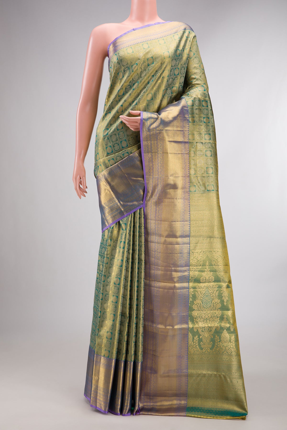 Green Dual Tone Kanchipuram Tissue Saree with Zari Brocade on the body and Zari Border.  displayed on a mannequin