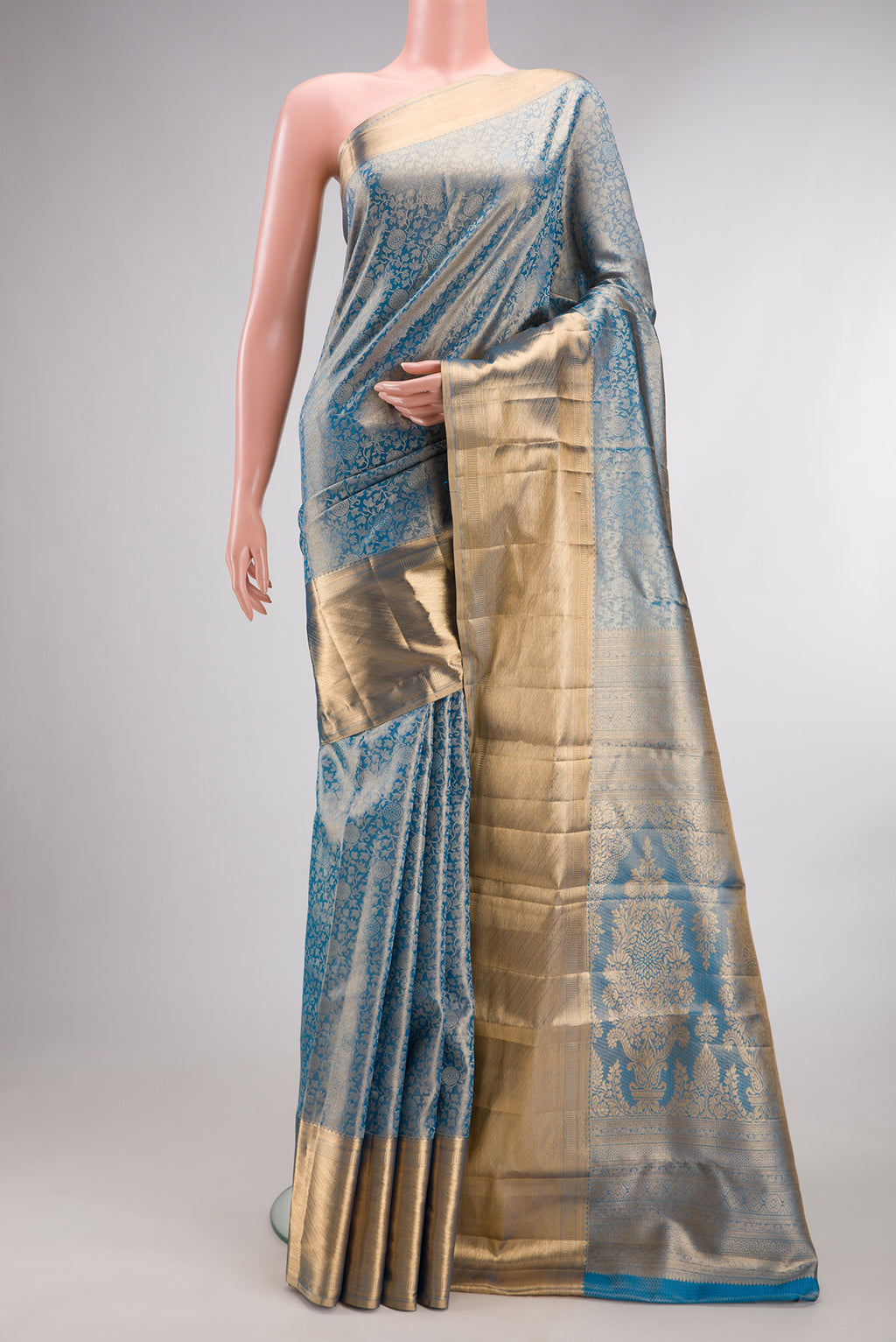 Peacock Blue Dual Tone Kanjivaram Tissue Saree with Zari Brocade on the body and Zari Border.  displayed on a mannequin
