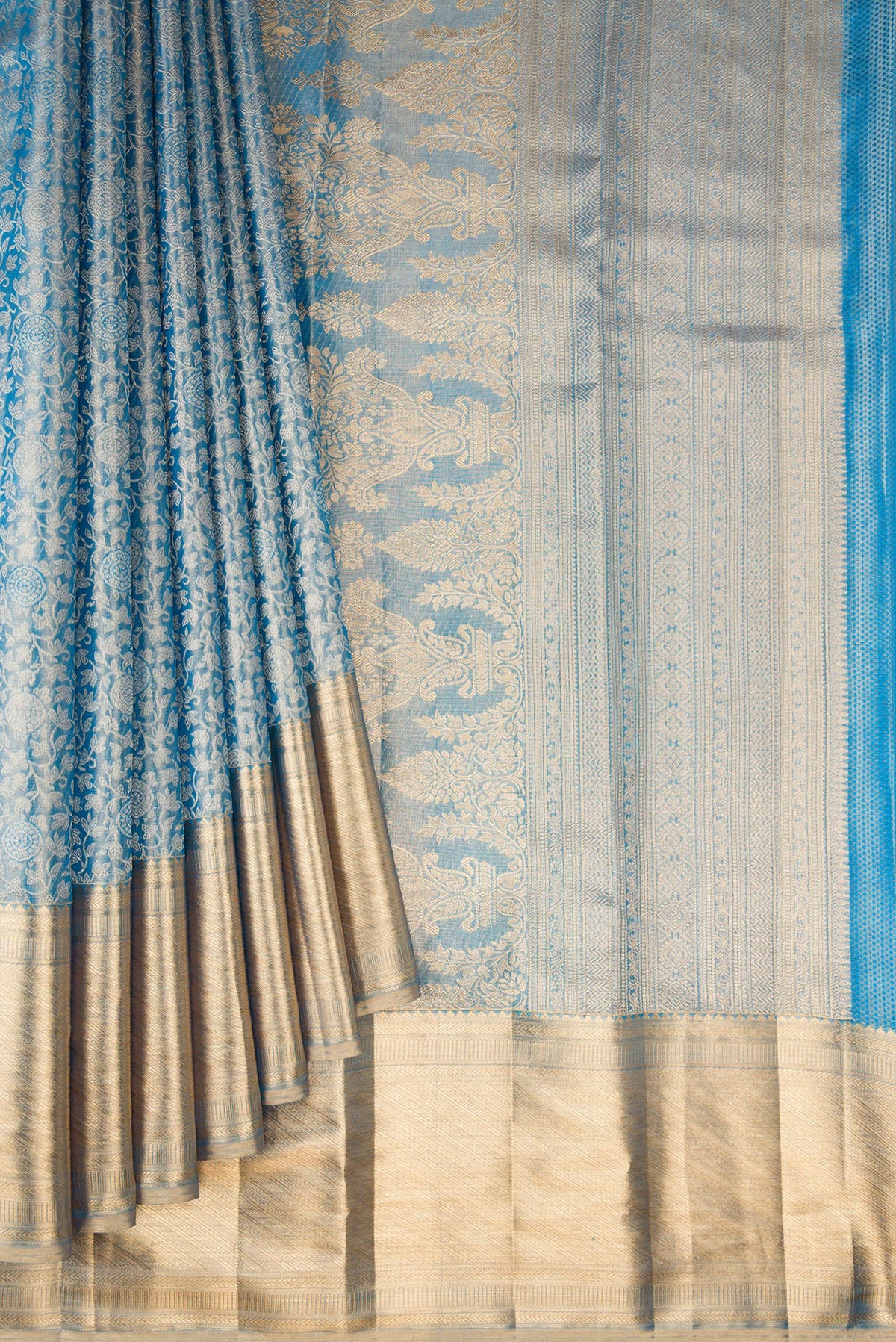 Pleats and pallu of Peacock Blue Dual Tone Kanjivaram Tissue Saree with Zari Brocade on the body and Zari Border. 