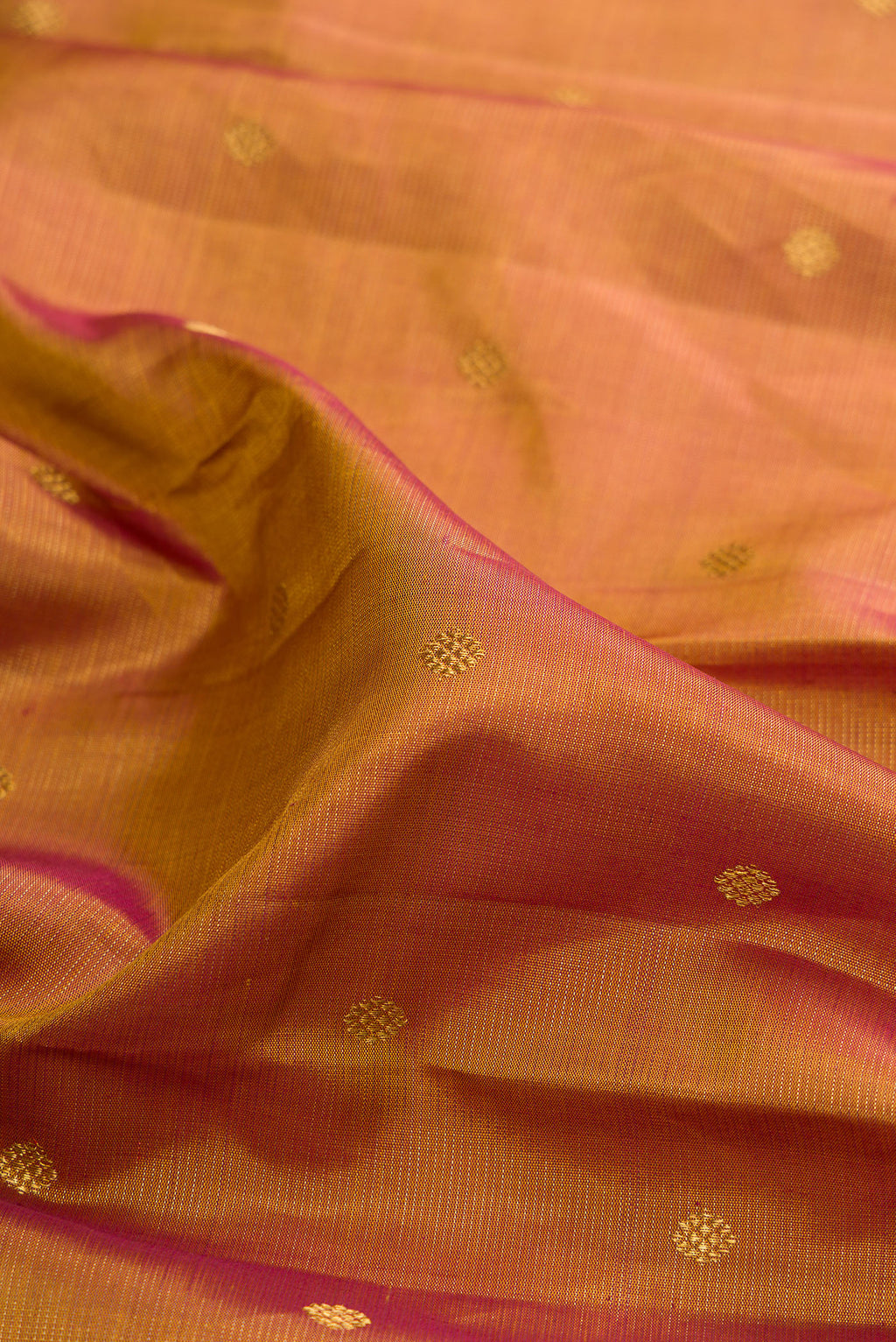 Close up of Pure Silk Mustard Kanjivaram Saree with Zari Butta on the body and Zari Border.  displaying folds