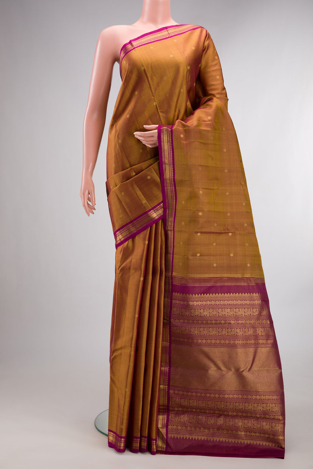 Pure Silk Mustard Kanjivaram Saree with Zari Butta on the body and Zari Border.  displayed on a mannequin
