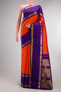 Pure Silk Orange Kanchipuram Saree with Zari Butta on the body and Zari Border.  displayed on a mannequin