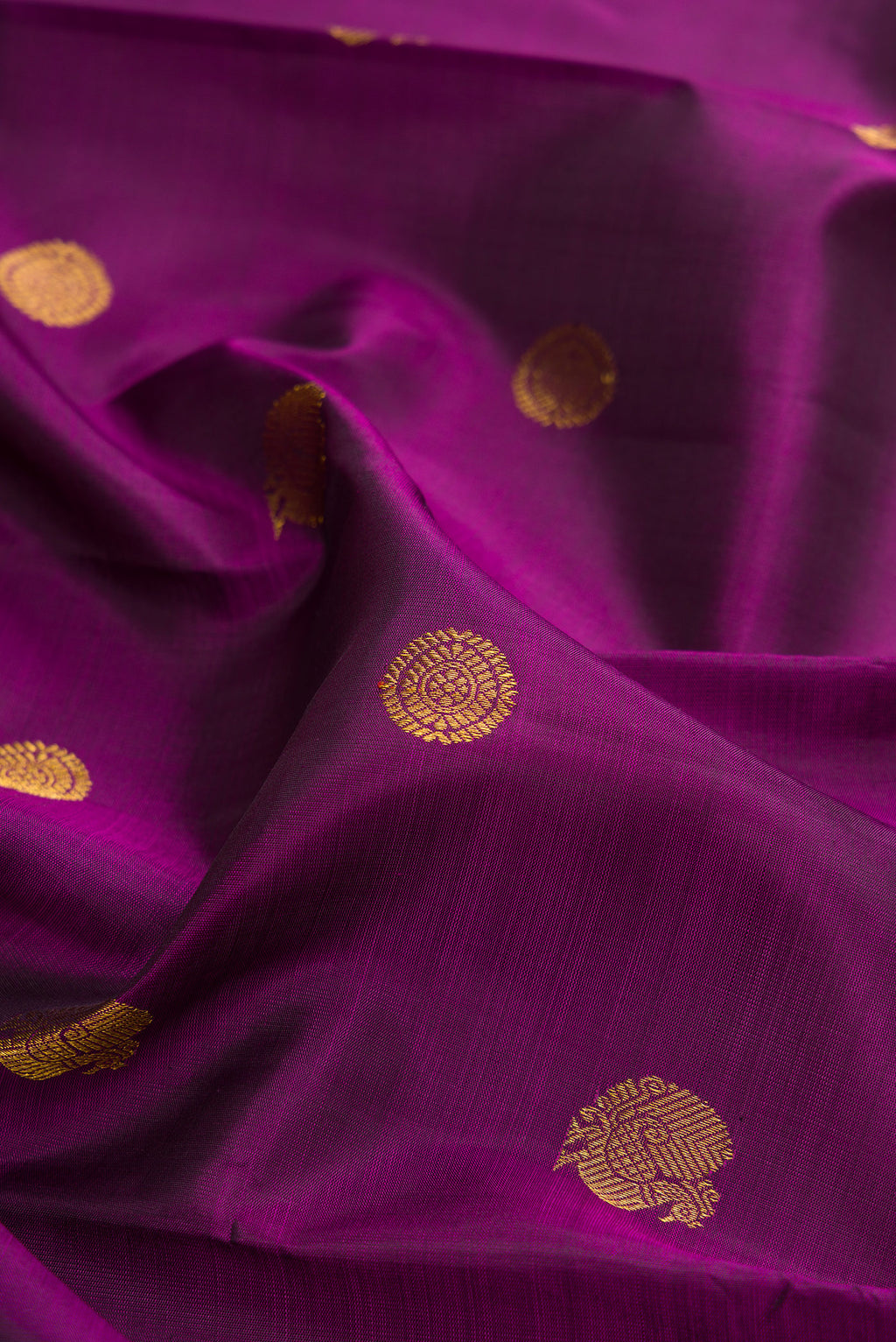 Close up of Pure Silk Purple Kanchipuram Saree with Zari Butta on the body and Zari Border.  displaying folds