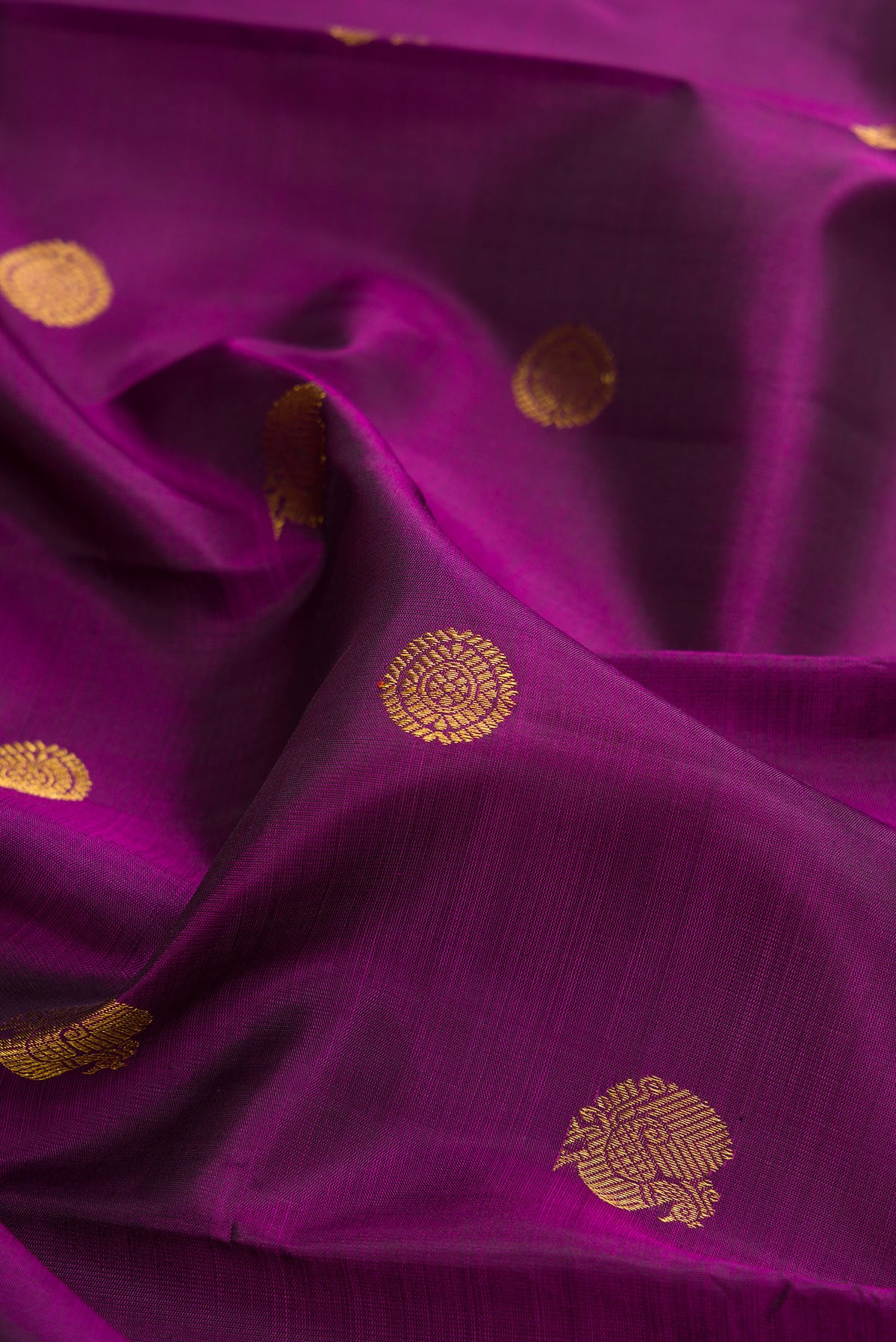 Close up of Pure Silk Purple Kanchipuram Saree with Zari Butta on the body and Zari Border.  displaying folds