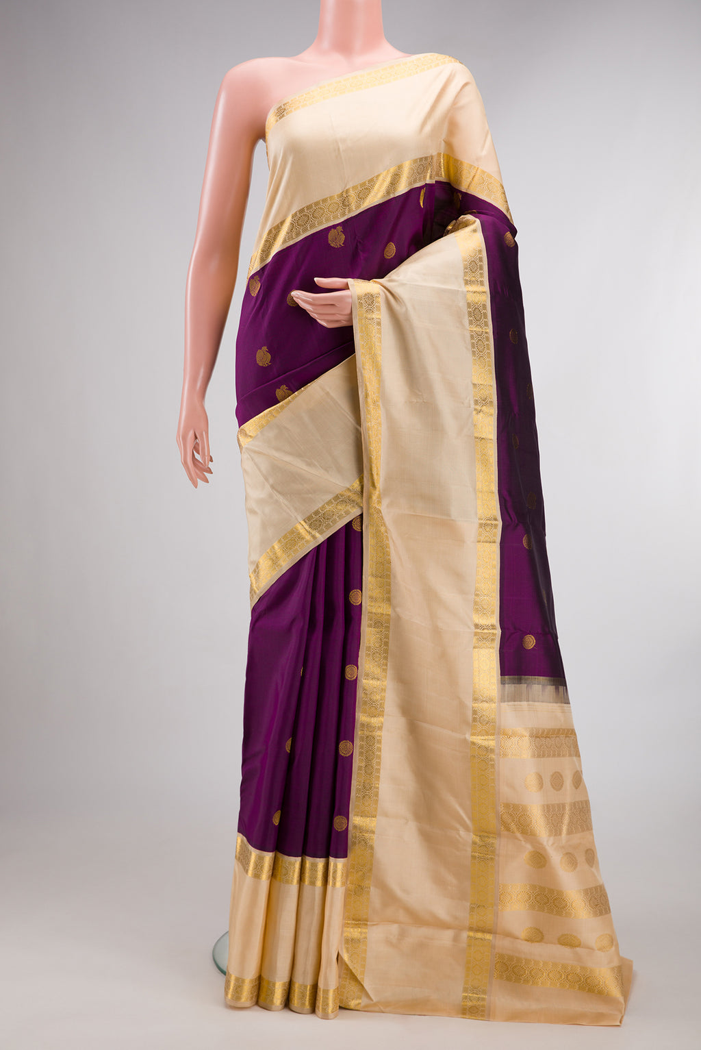 Pure Silk Purple Kanchipuram Saree with Zari Butta on the body and Zari Border.  displayed on a mannequin