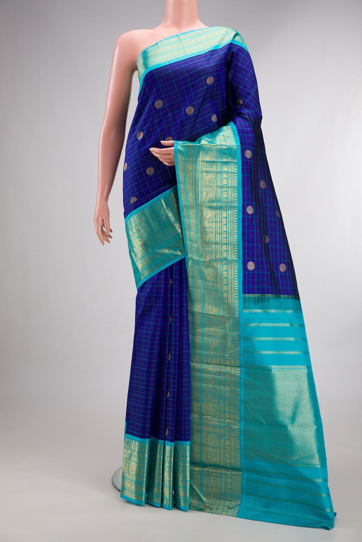 Pure Silk Royal Blue Kanchipuram Saree with Checked design on the body and Zari Border.  displayed on a mannequin