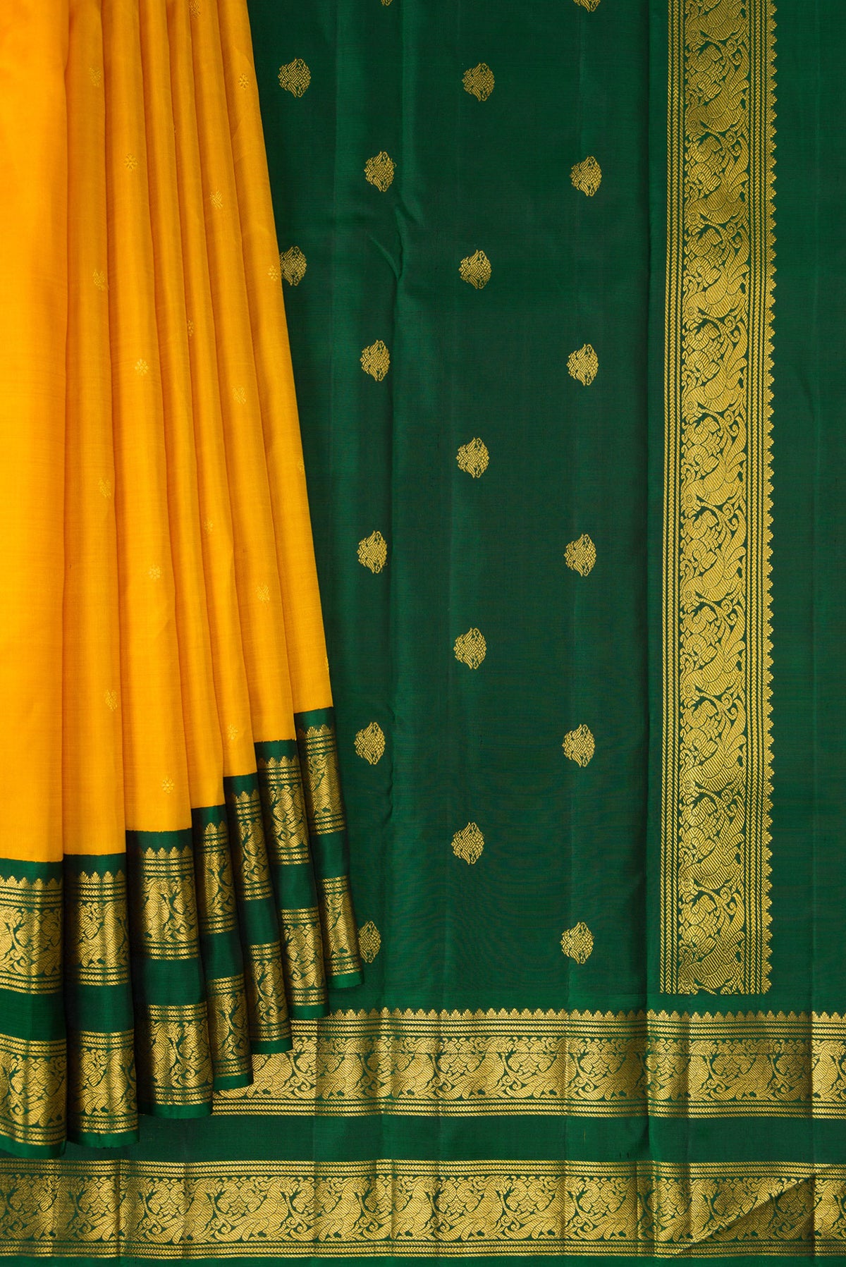 Pleats and pallu of Pure Silk Yellow Kanchipuram Saree with Zari Butta on the body and Zari Border. 
