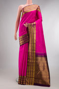 Pure Silk Rani Pink Kanchipuram Saree with Zari Butta on the body and Zari Border.  displayed on a mannequin