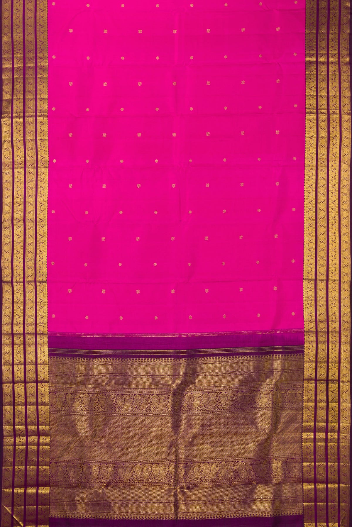 Flat view of Pure Silk Rani Pink Kanchipuram Saree with Zari Butta on the body and Zari Border. 