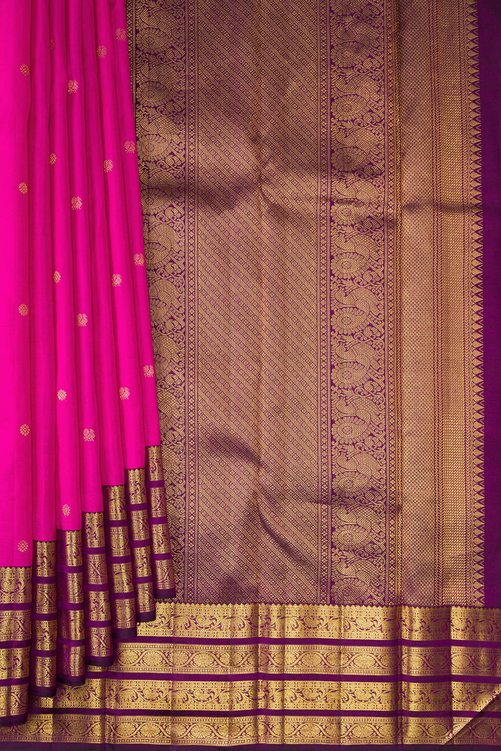 Pleats and pallu of Pure Silk Rani Pink Kanchipuram Saree with Zari Butta on the body and Zari Border. 