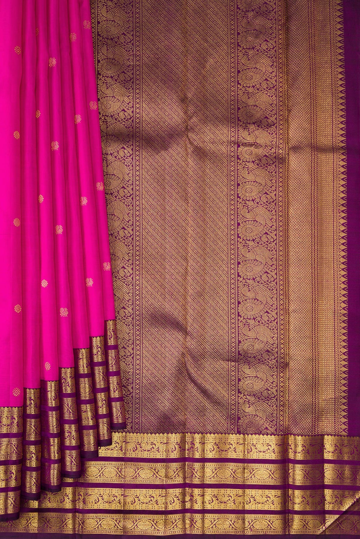 Pleats and pallu of Pure Silk Rani Pink Kanchipuram Saree with Zari Butta on the body and Zari Border. 