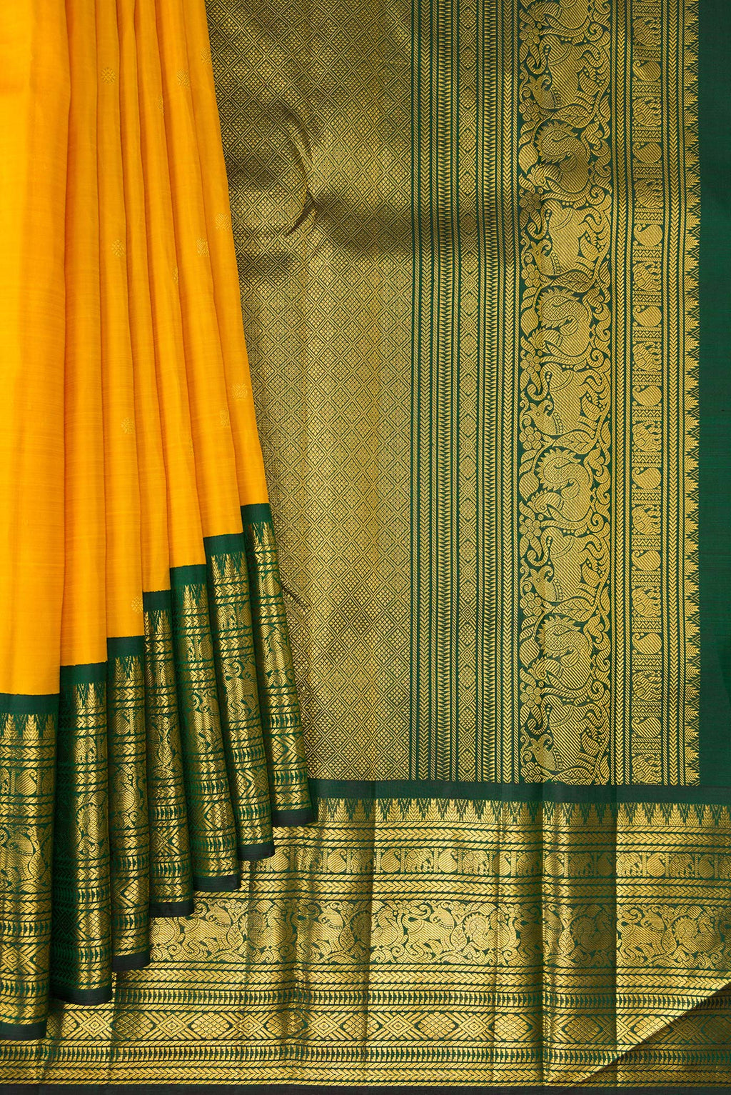 Pleats and pallu of Pure Silk Mustard Kanchipuram Saree with Zari Butta on the body and Fancy Border. 