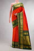 Pure Silk Orange Kanchipuram Saree with Zari Butta on the body and Zari Border.  displayed on a mannequin