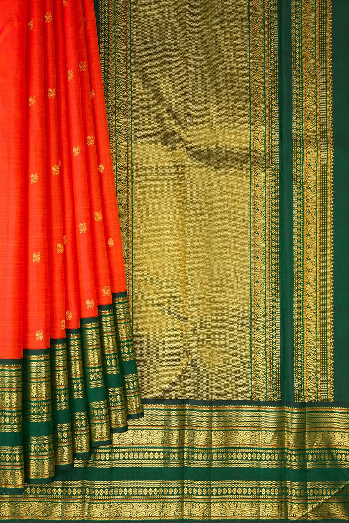 Pleats and pallu of Pure Silk Orange Kanchipuram Saree with Zari Butta on the body and Zari Border. 