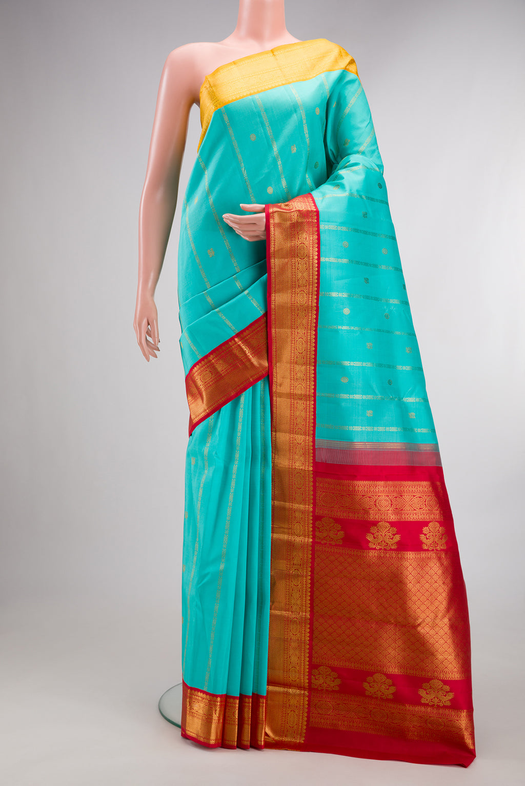 Pure Silk Turquoise Kanchipuram Saree with Stripes on the body and Ganga Jamuna Border.  displayed on a mannequin