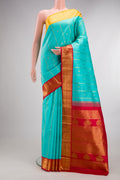 Pure Silk Turquoise Kanchipuram Saree with Stripes on the body and Ganga Jamuna Border.  displayed on a mannequin
