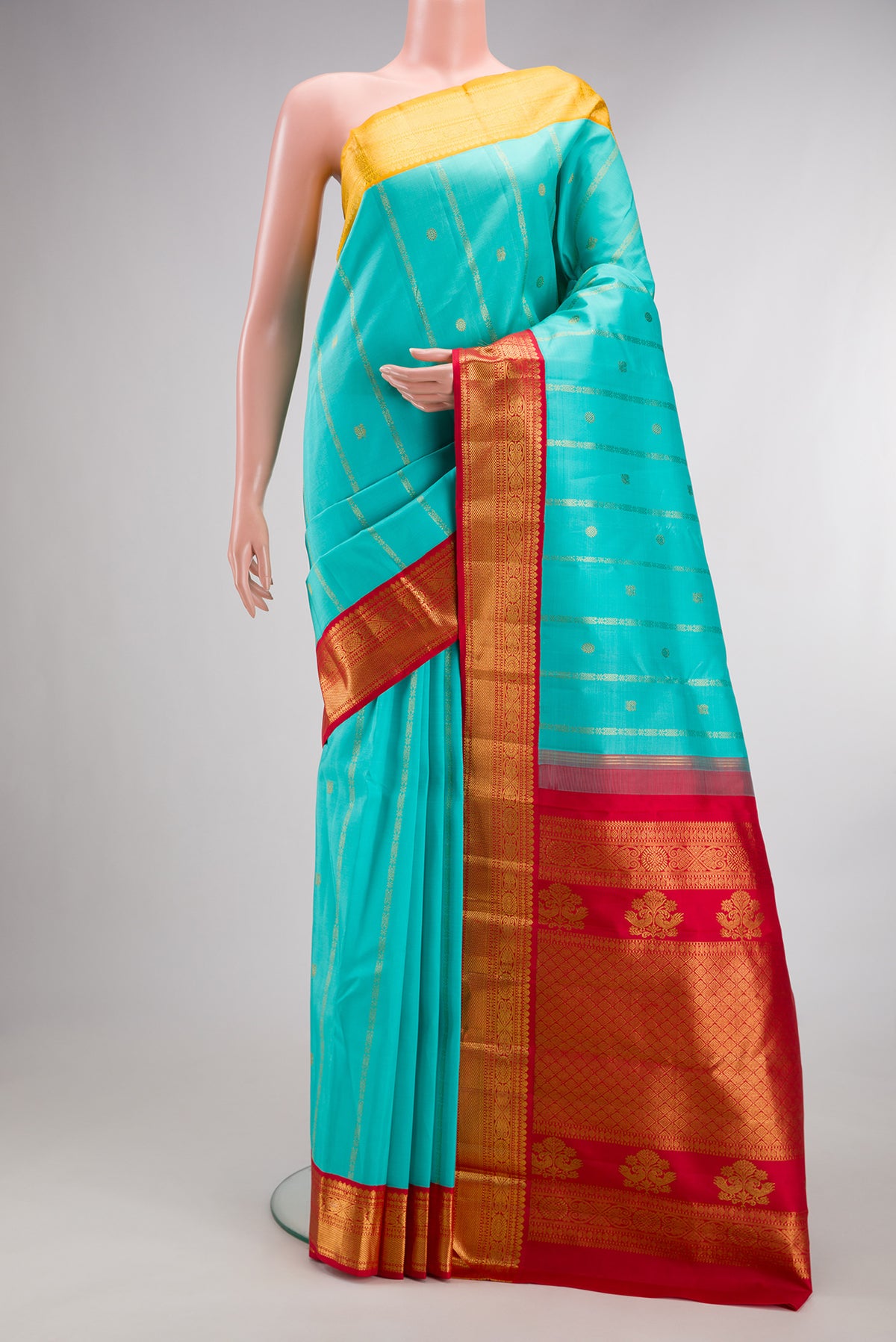 Pure Silk Turquoise Kanchipuram Saree with Stripes on the body and Ganga Jamuna Border.  displayed on a mannequin