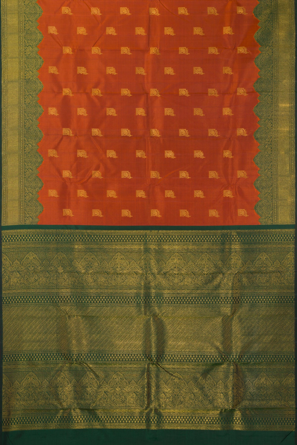 Flat view of Pure Silk Rust Kanchipuram Saree with Zari Butta on the body and Fancy Border. 