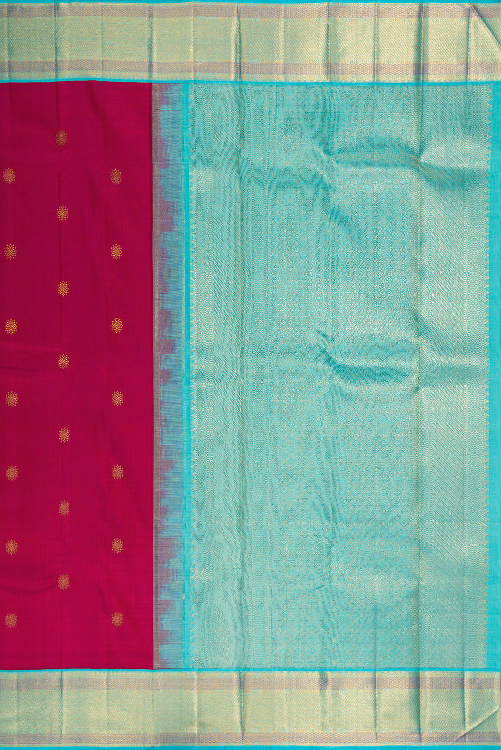 Close up image of the pallu of Pure Silk Dark Pink Kanchipuram Saree with Zari Butta on the body and Zari Border. 
