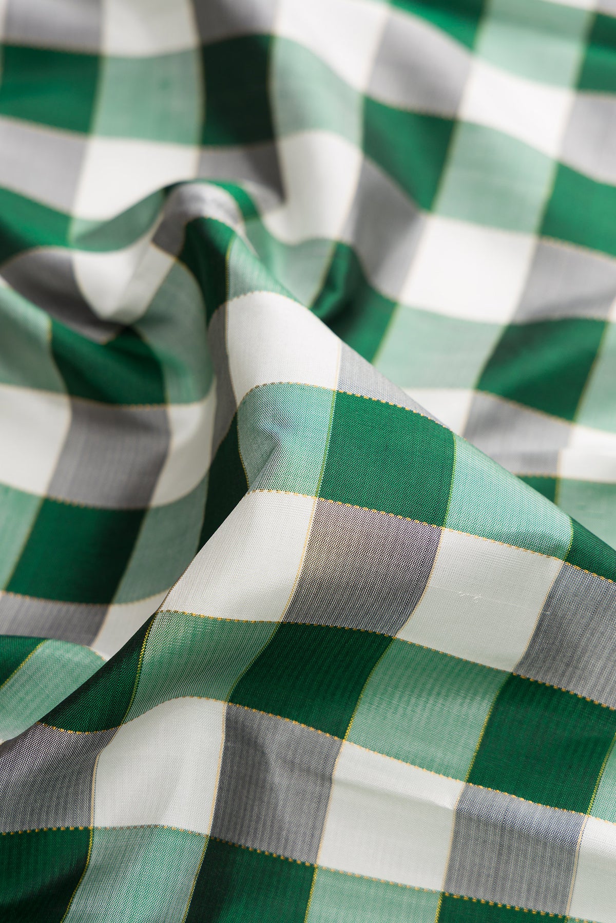Close up of Pure Silk Multi Color Kanchipuram Saree with Checked design on the body and Without Border.  displaying folds