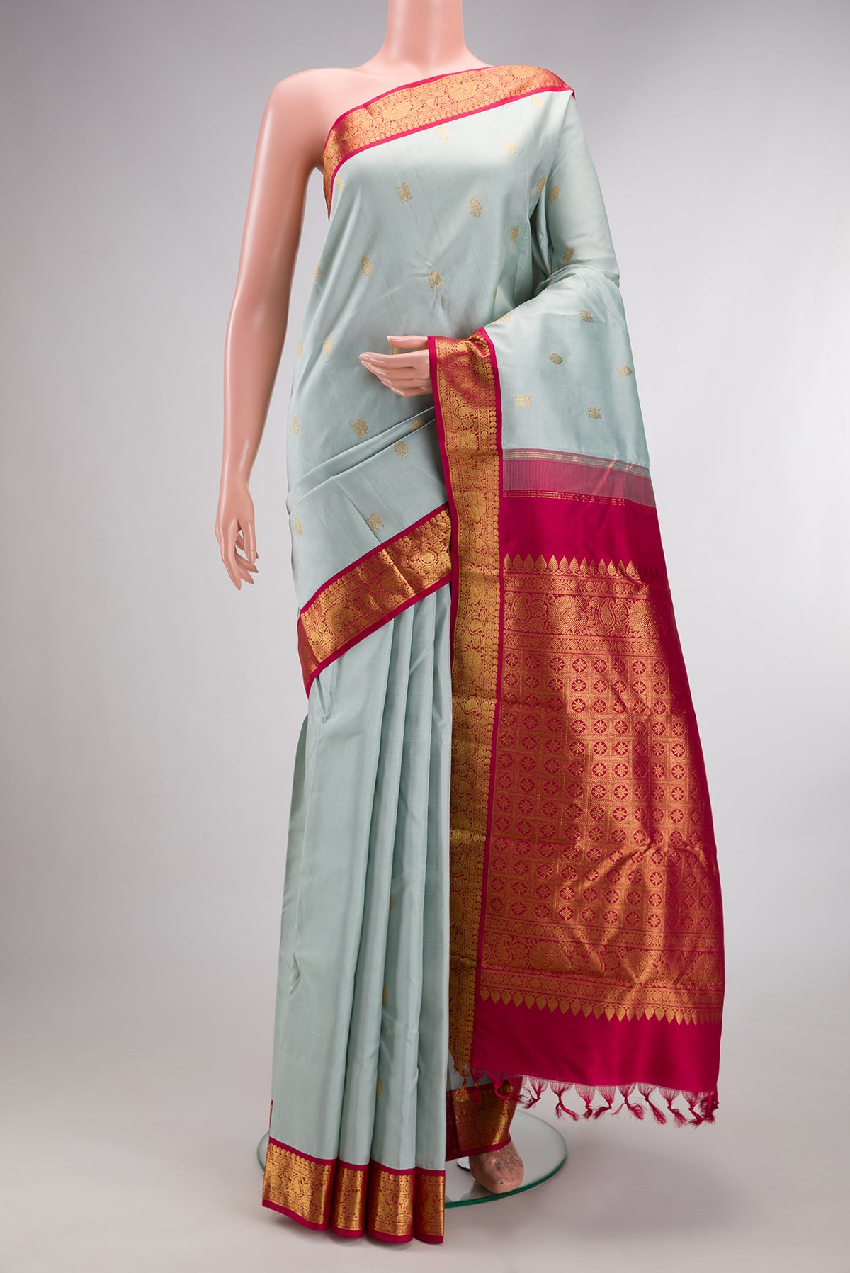 Pure Silk Light Blue Kanjivaram Saree with Zari Butta on the body and Zari Border.  displayed on a mannequin