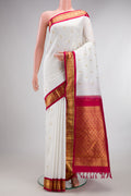 Pure Silk White Kanjivaram Saree with Zari Butta on the body and Zari Border.  displayed on a mannequin