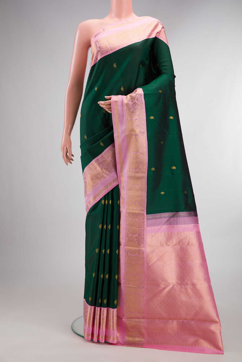 Pure Silk Bottle Green Kanchipuram Saree with Zari Butta on the body and Zari Border.  displayed on a mannequin