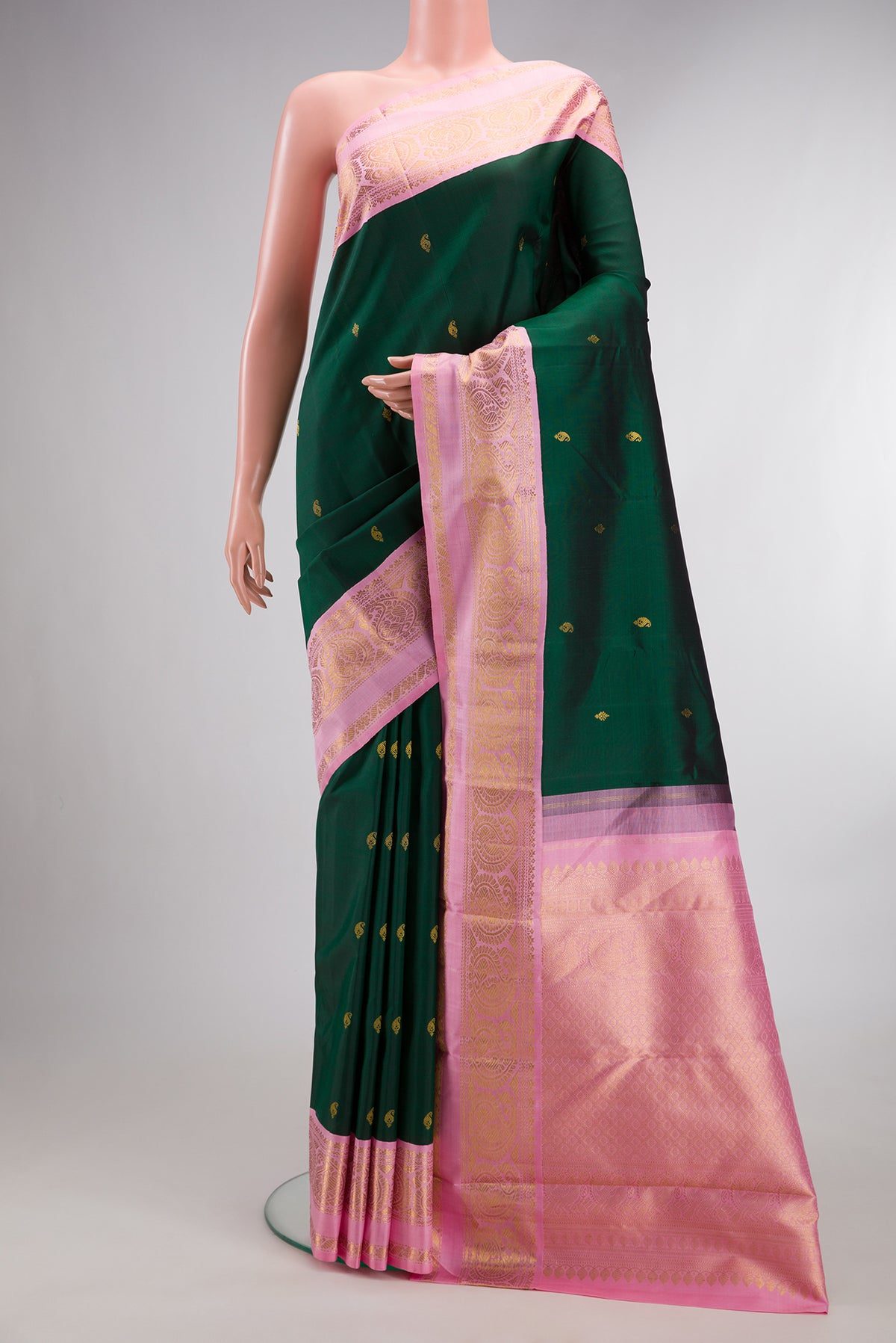 Pure Silk Bottle Green Kanchipuram Saree with Zari Butta on the body and Zari Border.  displayed on a mannequin