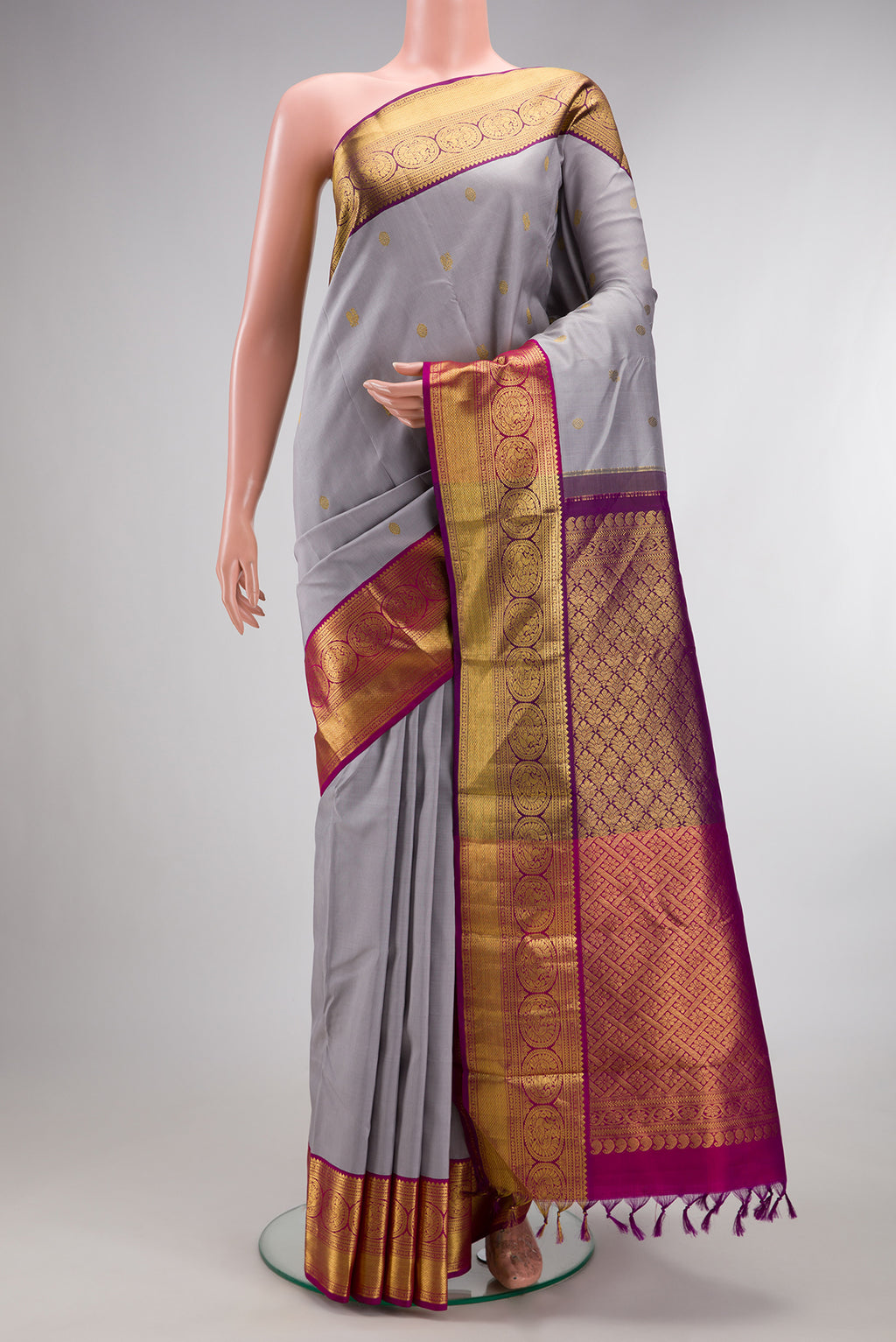 Pure Silk Grey Kanchipuram Saree with Zari Butta on the body and Zari Border.  displayed on a mannequin